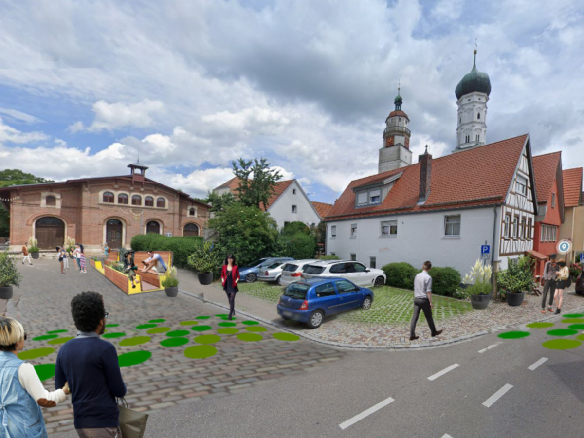 Blick auf die Obertorstra&szlig;e mit historischen Geb&auml;uden, Kopfsteinpflaster, parkenden Autos und einer Kirche im Hintergrund. Fu&szlig;g&auml;nger bewegen sich auf dem Gehweg und der Stra&szlig;e, umgeben von gr&uuml;nen Pflanzenelementen.